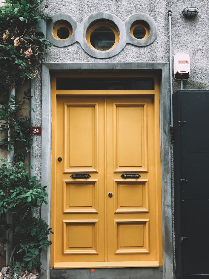 A striking yellow door with architectural details in Üsküdar, Istanbul. Perfect for design inspiration.